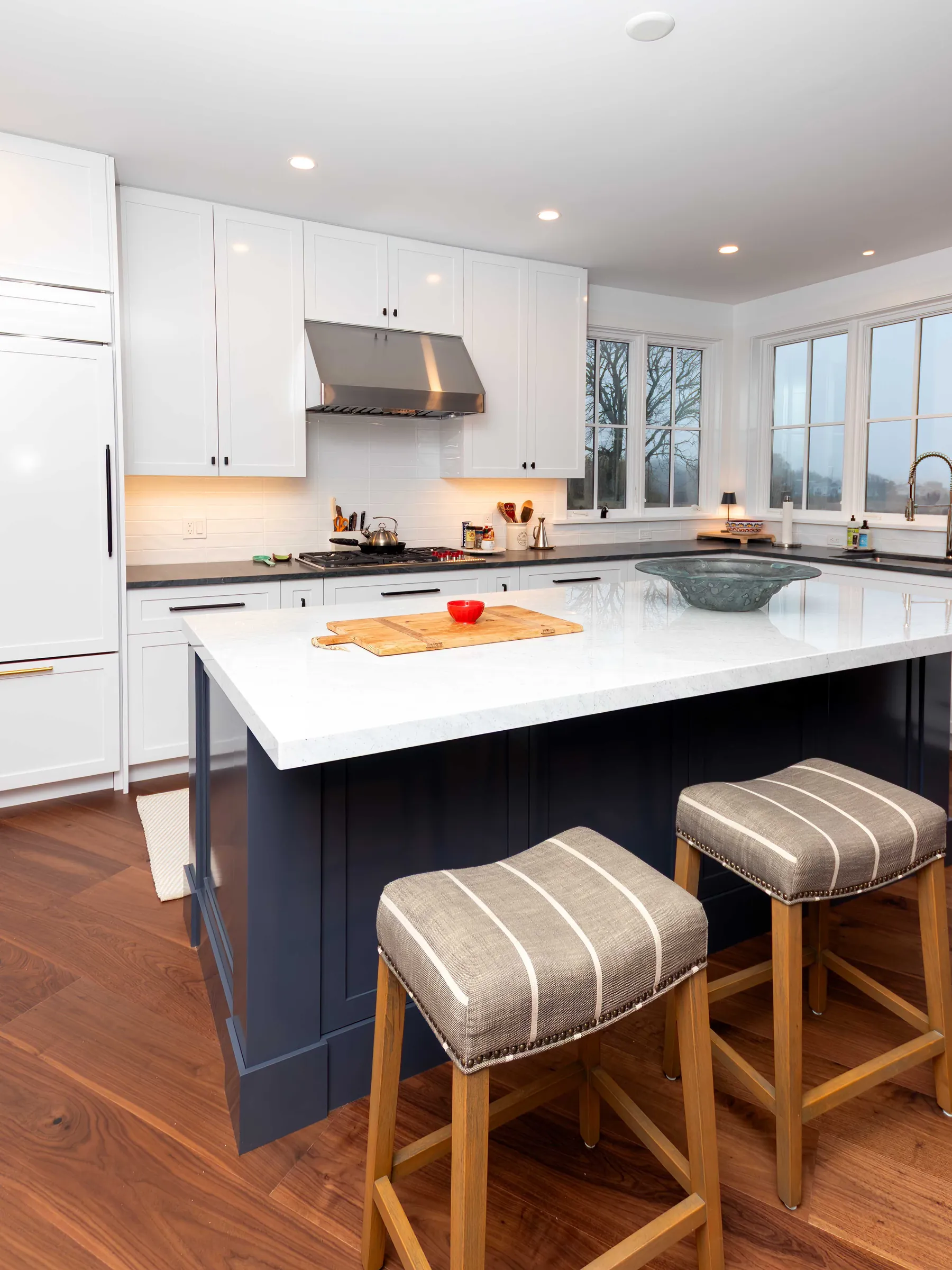 Open kitchen remodel with island seating and warm wood cabinetry